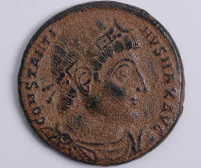 An authentic ancient Roman bronze follis featuring the GLORIA EXERCITVS type. Struck in the 4th century AD, this coin depicts an imperial portrait on the obverse and honors the Roman army on the reverse.