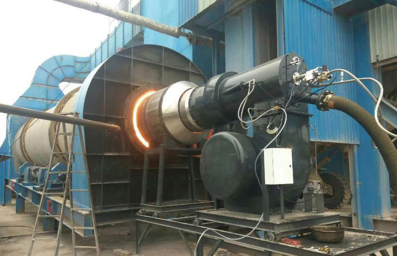 Industrial combustion device burning coal-oil mixture, connected to a rotary dryer system