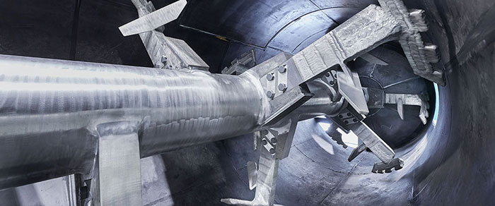 Inside view of a ploughshare mixer showing plough-shaped blades and horizontal drum for efficient dry powder mixing