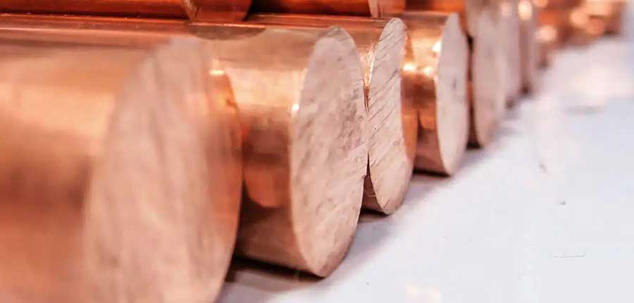 Polished copper bars stacked in a warehouse. Refined copper is widely used in electrical, construction, and manufacturing industries due to its excellent conductivity and durability.
