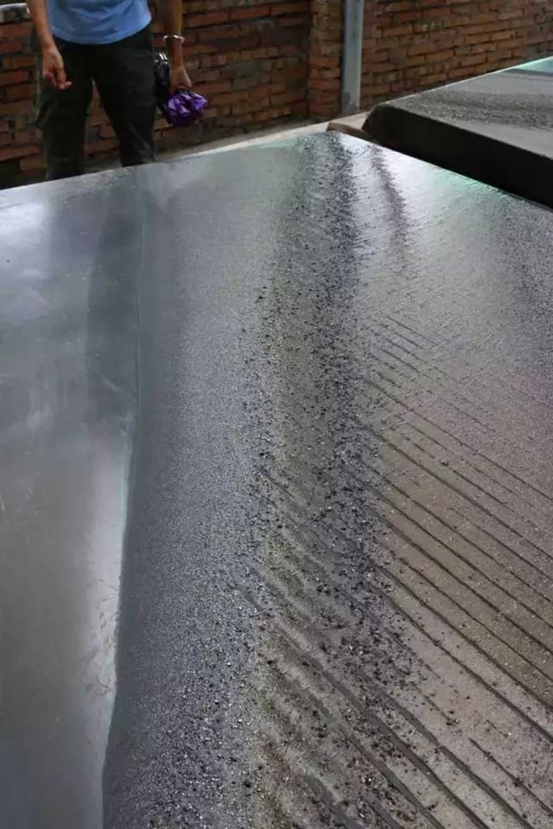Gravity separation of tungsten ore using a shaking table.