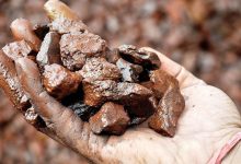 a man is taking some washed and graded iron ore in hand
