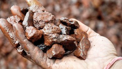 a man is taking some washed and graded iron ore in hand