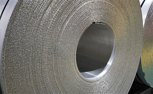 Metal strip coil mounted on uncoiler in processing line