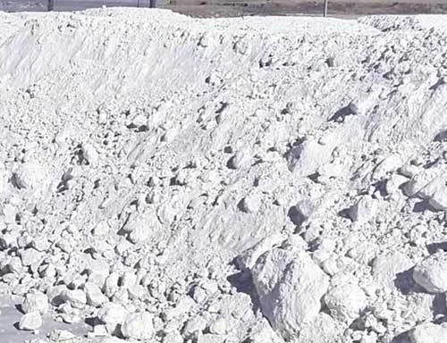 Potassium sulfate (SOP) raw material in bulk storage, used as feedstock for dry granulation and roller compactor processing